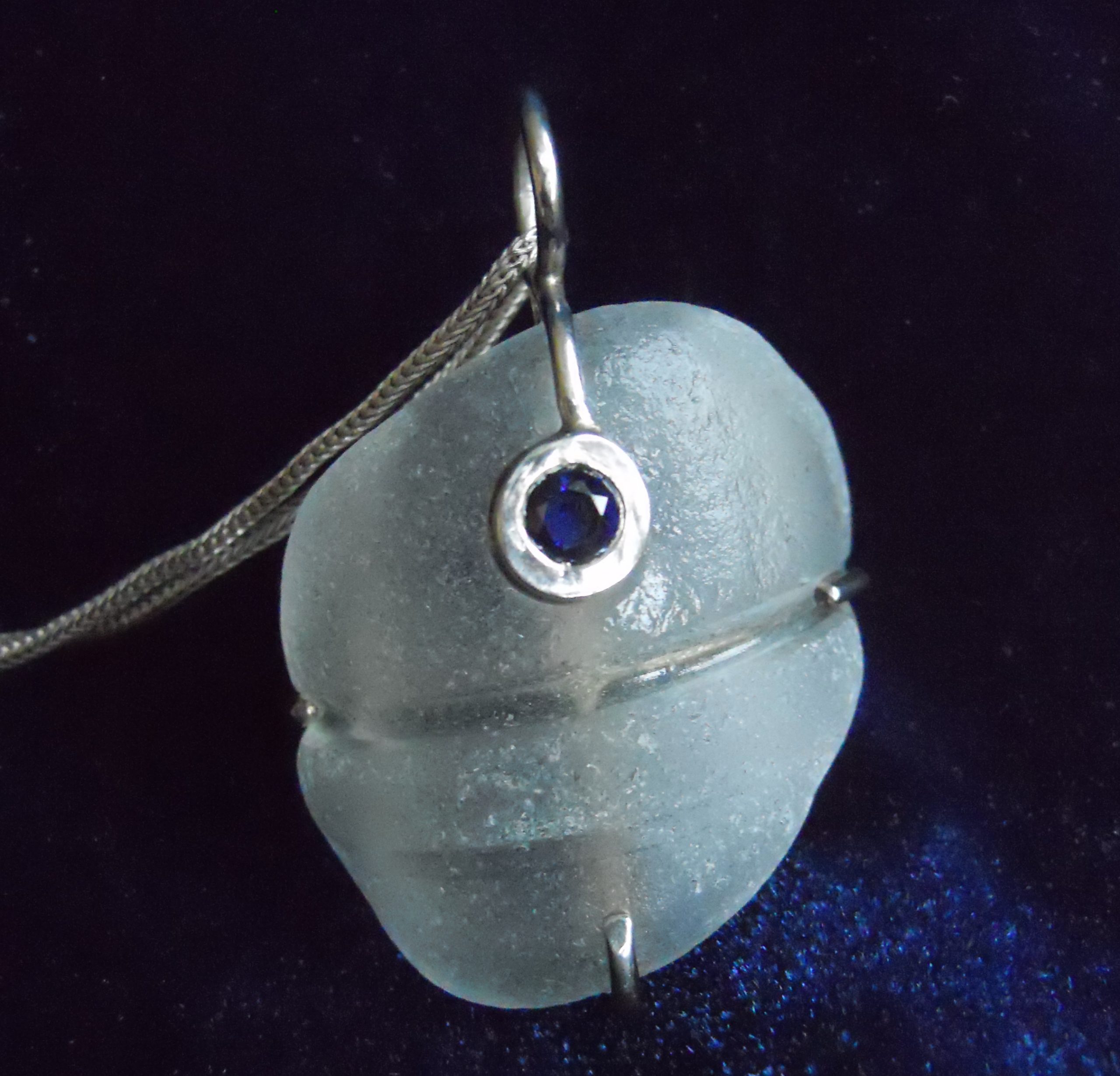 Blue sapphire set over light blue beach glass (pendant in Sterling silver)