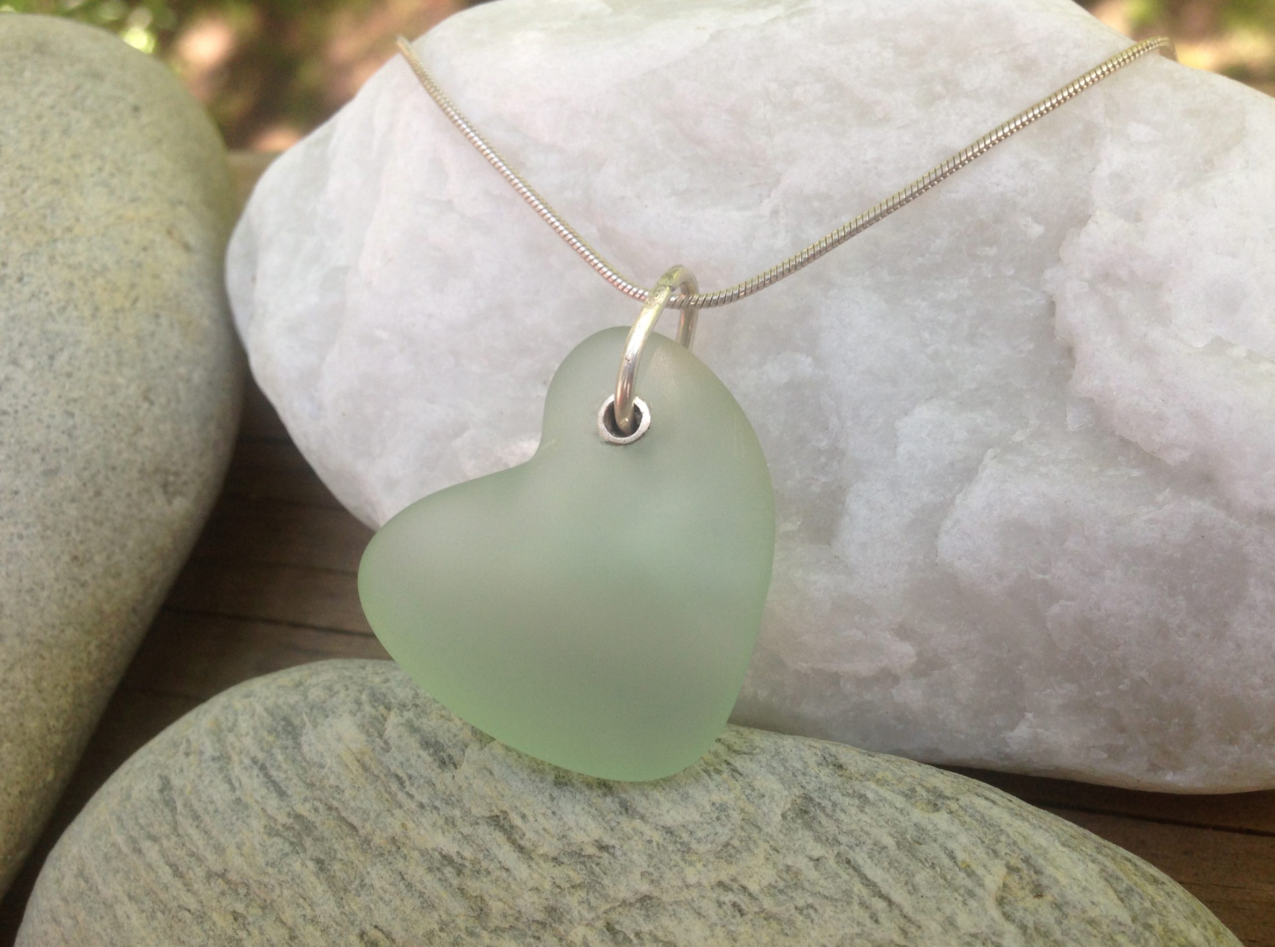 Drilled beach glass (heart shaped) with silver grommet