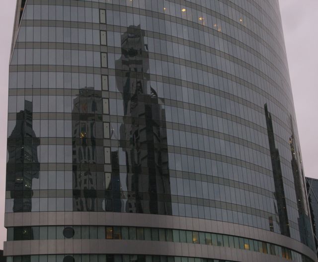 Reflections of neighboring buildings in black glass